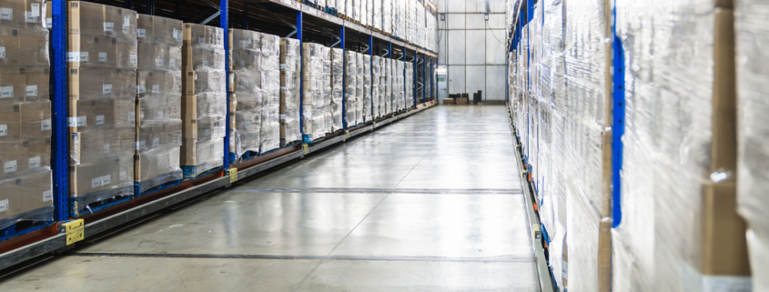view down the aisle of a cold storage warehouse full of goods