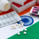 various packaged medications on top of an Indian flag