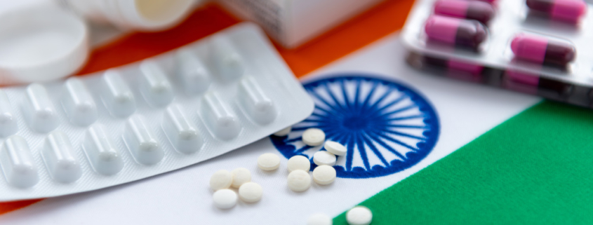 various packaged medications on top of an Indian flag